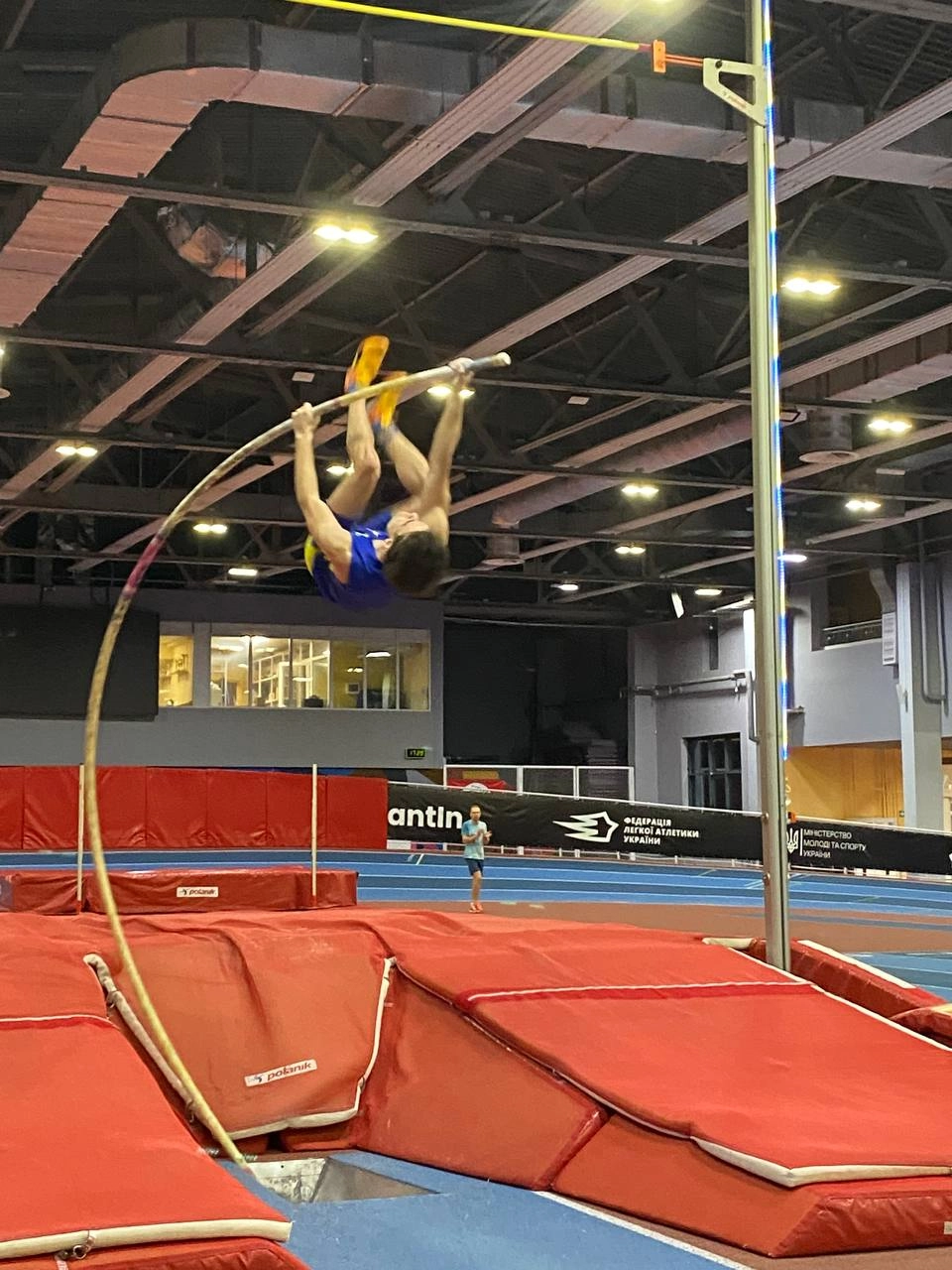 Ukrainian pole vault competition featuring athletes in action at an indoor track and field event, showcasing technique and...