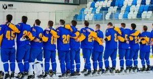 Українська хокейна збірна готується до матчу, стоячи в формі з синіми та жовтими елементами.