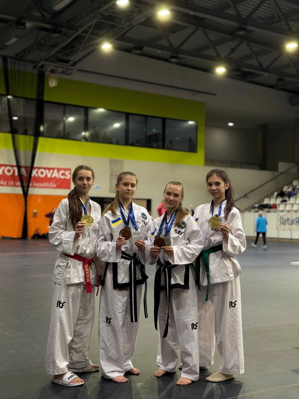 Ukrainian Taekwondo team proudly showcasing medals at the XII MIGHTYFIST OPEN EAGLES CUP in Hungary, October 2025.