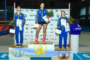 Winners of the Ukrainian Modern Pentathlon Championship in Kyiv, celebrating on the podium with certificates and flowers.