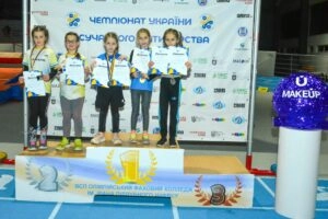 U9 girls winners at the Ukrainian Modern Pentathlon Championship in Kyiv, celebrating their achievements on the podium.