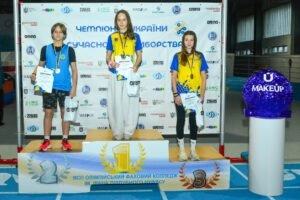 Ukrainian Modern Pentathlon Championship winners on podium in Kyiv, celebrating their achievements with medals and certifi...