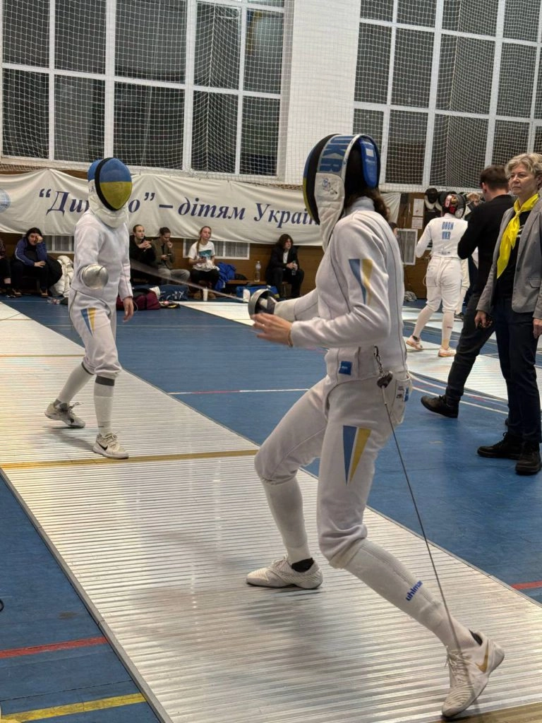 Alt text: "Fencers compete at the U-23 National Championships, December 20, celebrating Grigoriy Kris