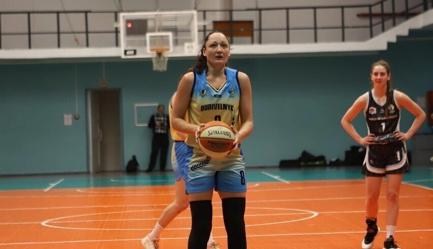 Female basketball player preparing to shoot during a match in the Ukrainian Cup, showcasing competitive spirit and skill.