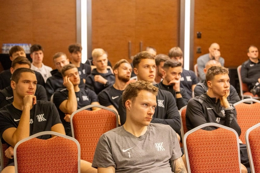 Футболісти УПЛ уважно слухають презентацію на зустрічі з Катериною Монзуль у конференц-залі