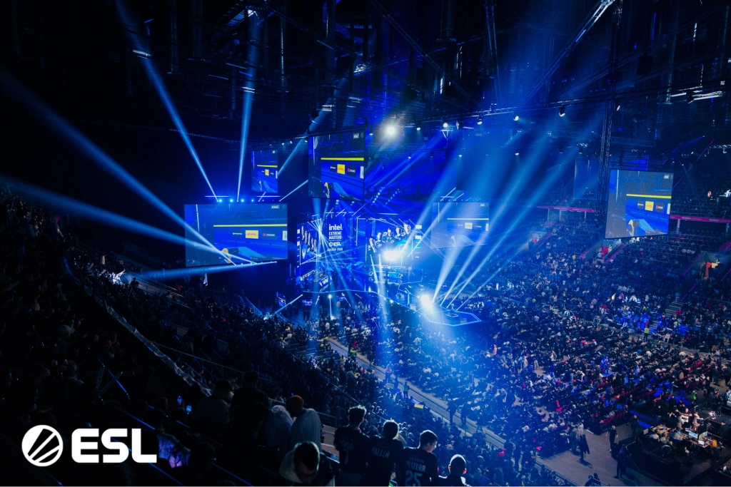 Велика арена з яскравими вогнями під час турніру з Counter-Strike, глядачі спостерігають за грою