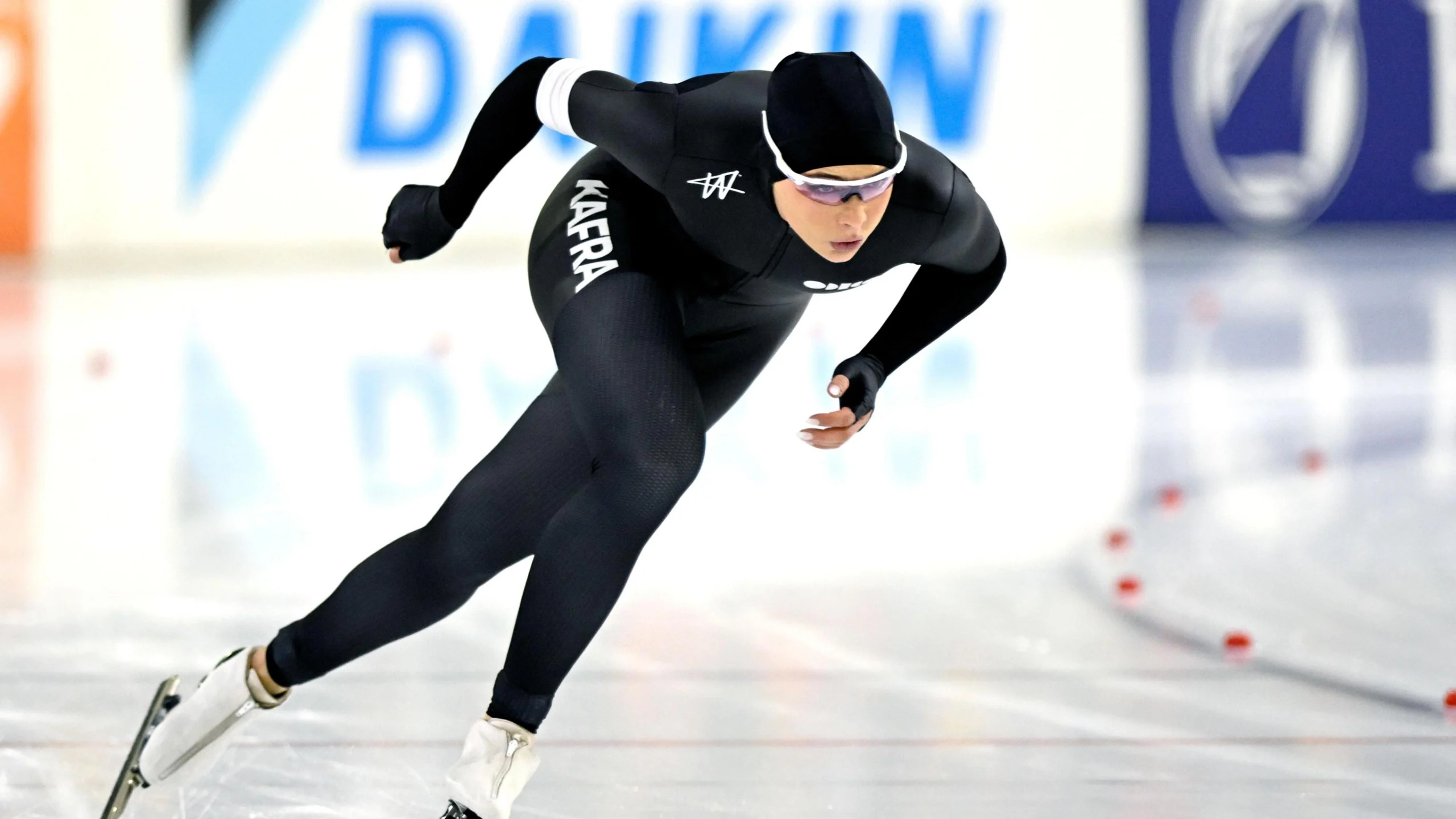 Спортсмен у чорному костюмі ковзає на льоду під час змагань з ковзанярського спорту на Олімпіаді 2026